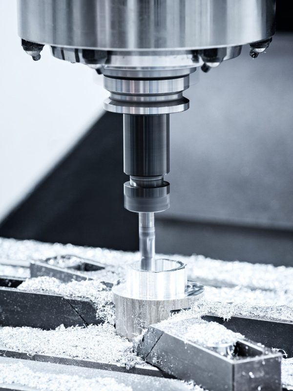 The Hi-precision CNC milling machine with cutting sample in blue-silver tone.The micro cutting technique in precision part.